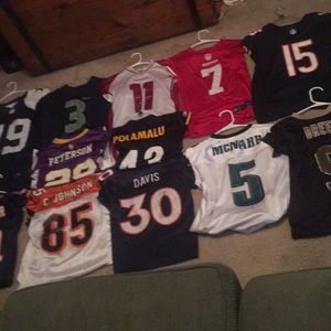 12 NFL jerseys. Jerseys on top row are stitched